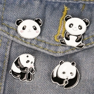 Cute cartoon panda enamel brooch 4-piece set displayed on a blue denim jacket pocket