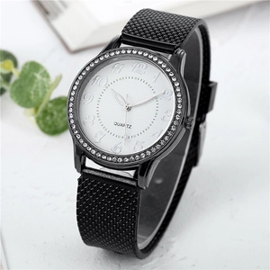 Detailed macro view of white watch face with crystal bezel and black mesh strap
