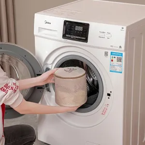 Beige cylindrical mesh laundry bag for washing machines with protective zipper closure