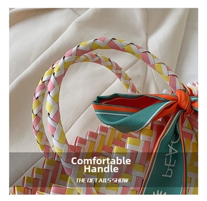 Detail of woven beach tote with pink and yellow texture and striped decorative bow