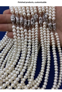 Close-up of natural freshwater pearl necklaces with elegant floral silver clasps