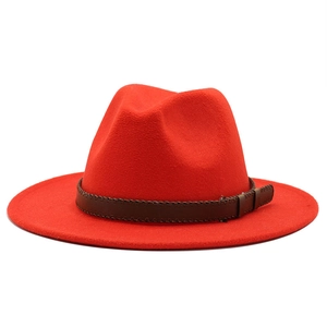 Elegant red wool fedora hat with brown braided leather band on white background