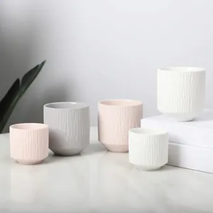 Minimalist ceramic scented candle jars with vertical ribbed texture in assorted colors