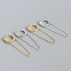 Detail of s925 silver geometric tassel chain earrings in gold and silver finish