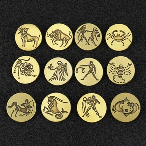 Collection of 12 vintage bronze zodiac badges featuring detailed celestial engravings