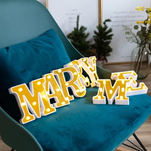 Golden LED alphabet lights spelling MARRY ME for romantic proposal and wedding decor