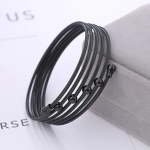 Black multilayer twisted cable stainless steel bangle with polished bead details