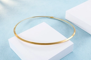 Detailed view of gold plated titanium choker featuring a minimalist flat beveled edge design