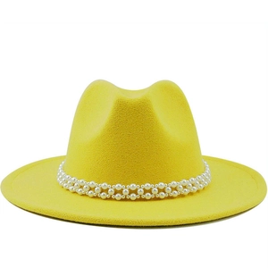 Elegant yellow wool fedora hat with a decorative white pearl band on a white background
