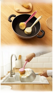 Detail of long-handle kitchen scrub brush with dense bristles and a convenient hanging hole