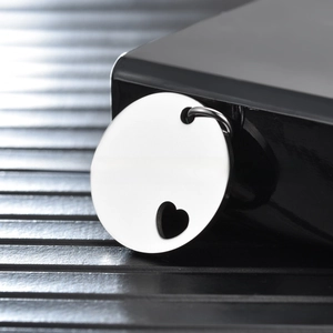 Polished stainless steel round pet tag featuring a heart-shaped cutout and metal ring