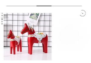Detailed view of red wooden Dala Horses with traditional floral patterns and history