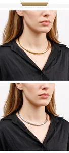Close-up of minimalist gold and silver titanium steel necklaces worn by a model