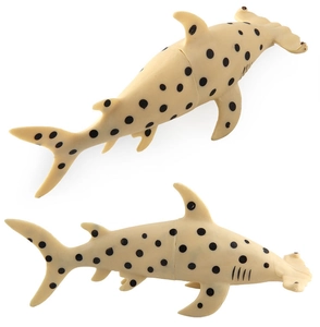 Detailed close-up of two beige hammerhead shark toy figures with realistic black spots
