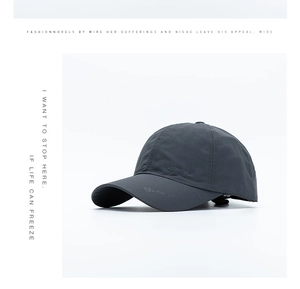 Detail of dark grey quick-dry baseball cap with KAIRUI logo and textured breathable fabric