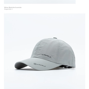 Detail of light gray quick-dry baseball cap featuring breathable texture and brand lettering