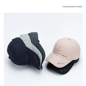 Close-up of stacked quick-dry baseball caps in black grey and beige with KAIRUI logo