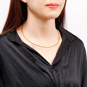 Minimalist gold plated stainless steel snake chain necklace shown on a model neck