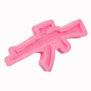 Pink silicone rifle mold for DIY chocolate, fondant, and clay crafts on white background