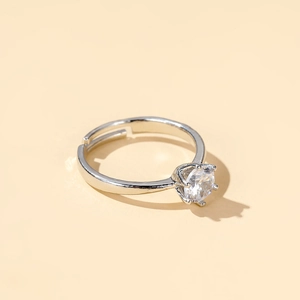 Detail of classic crown ring with six-prong set cubic zirconia and adjustable silver band