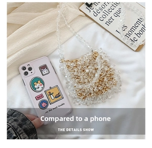 Clear acrylic beaded evening bag with gold chain showing mini size compared to smartphone