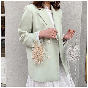Close-up of handmade acrylic waterdrop bead bags in transparent white and champagne gold