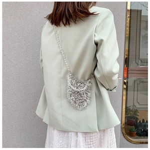 Detailed view of handmade clear acrylic beaded mini bag with elegant teardrop fringe