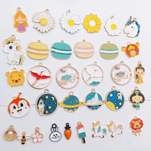 Close-up of colorful enamel charms featuring various cartoon, animal, and flower shapes