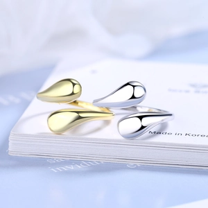 Minimalist interwoven open rings in gold and silver finish with teardrop design