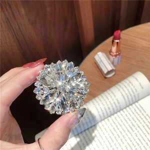 Close-up of a sparkling crystal flower phone ring stand on an elegant lifestyle background