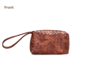 Close-up of the woven texture and top zipper on a brown faux leather clutch bag