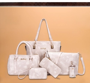 Detailed view of 6-piece white handbag set with woven texture and gold zippers