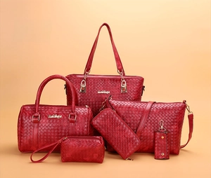 Detail of 6-piece red handbag set with woven texture and gold hardware accessories