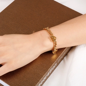 Elegant gold Cuban chain heart bracelet with CD logo charm and toggle clasp closure