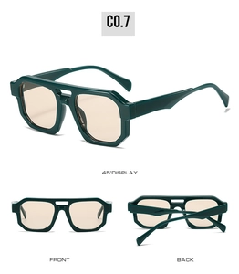 Detail view of dark green irregular sunglasses with double bridge and tan lenses