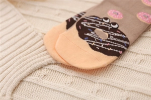 Close-up of cotton socks with cartoon donut patterns and high-quality stitched toe detail