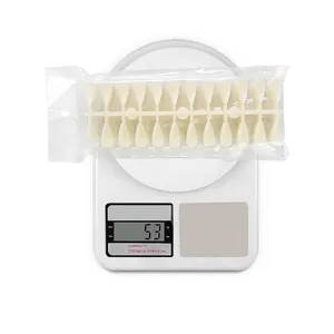 240pcs almond pointed almond nail tips in cream white on scale showing 53g weight