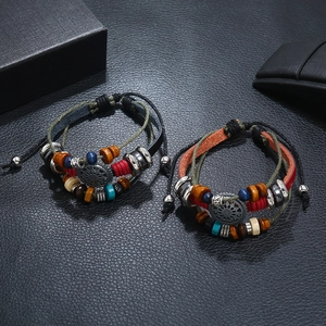 Detail of bohemian layered leather bracelet with sun pendant and colorful beads