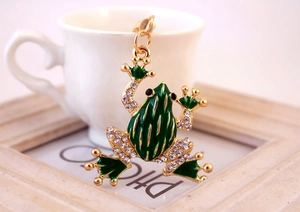 Close-up of green crystal frog keychain with gold plating and sparkling rhinestones