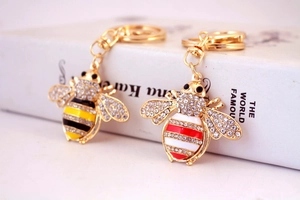 Detailed view of crystal bee keychains with rhinestones and gold plating finish