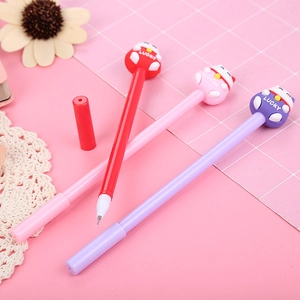 Three cute lucky cat cartoon gel pens in red, pink, and purple on a pink grid mat