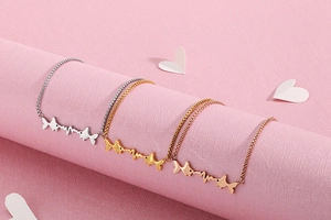 Detailed close-up of fish and heartbeat bracelets in silver, gold, and rose gold finishes