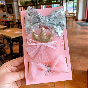 Detailed view of baby headband set with silver sequins, gold crown and pink lace bow