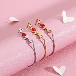 Elegant heartbeat bracelet with red heart and paw charms in gold and silver finishes