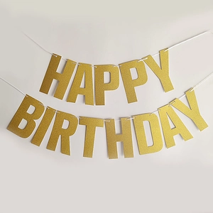 Close-up of golden glitter Happy Birthday banner with elegant shimmering lettering