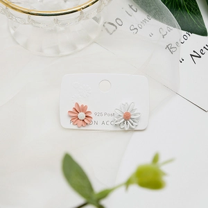 Detailed view of pink and white daisy stud earrings on 925 silver needles display card