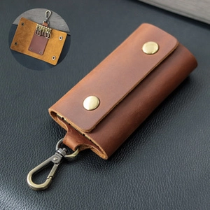 Detail of vintage brown crazy horse leather key case with metal snaps and 6 key hooks