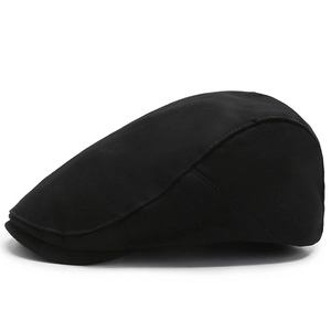 Classic black cotton ivy cap with flat top and reinforced stitching in a minimalist style
