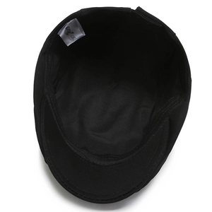 Interior view of black cotton flat cap featuring inner sweatband and size label