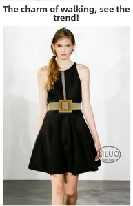 Detail of woven khaki waist belt with square buckle on a black mesh sleeveless dress